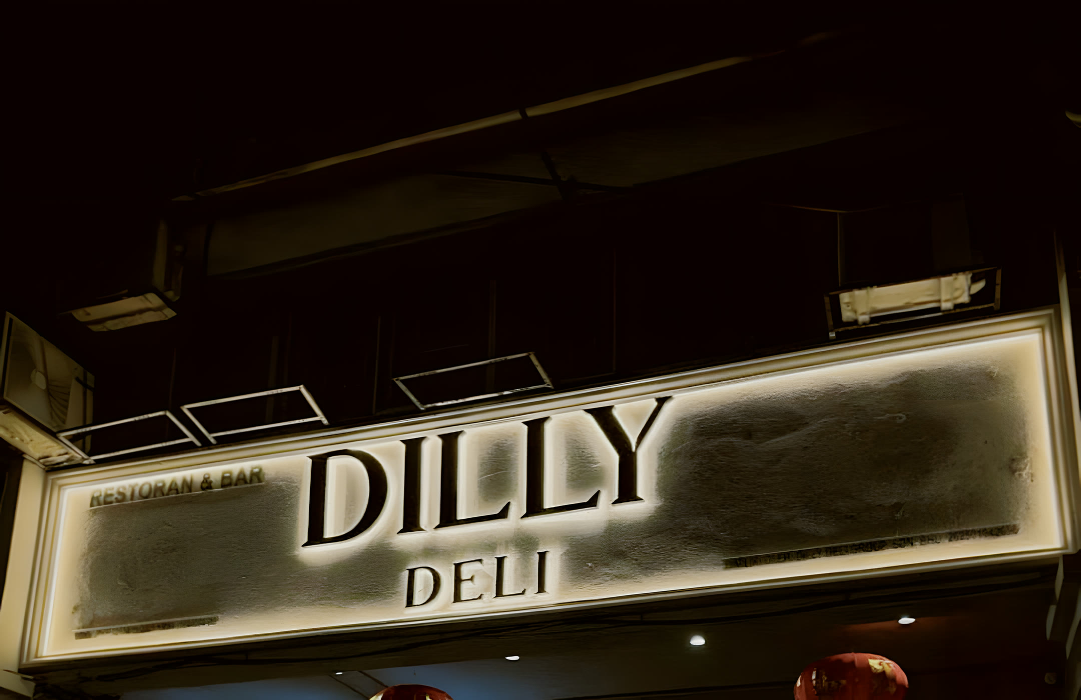 Dilly Deli Restoran & Bar sign lit at night on Jalan Sarjana, Taman Connaught